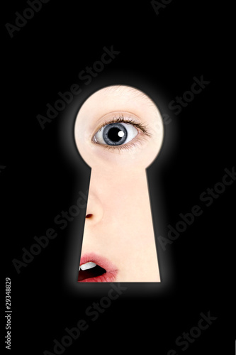 A boy looking in a keyhole