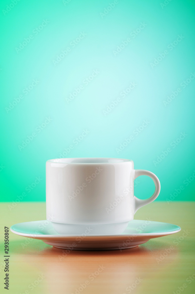 Fototapeta premium White cup against colourful gradient on the table
