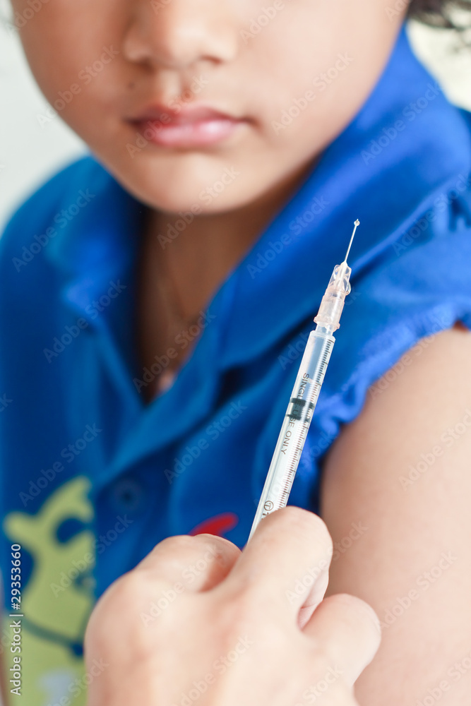 Boy and vaccine syringe Boy and vaccine syringe