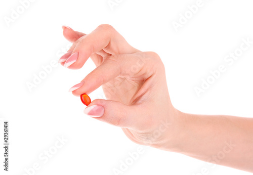 capsule of vitamin E in the hand on a white background