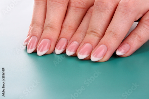nails with a French manicure on a blue background