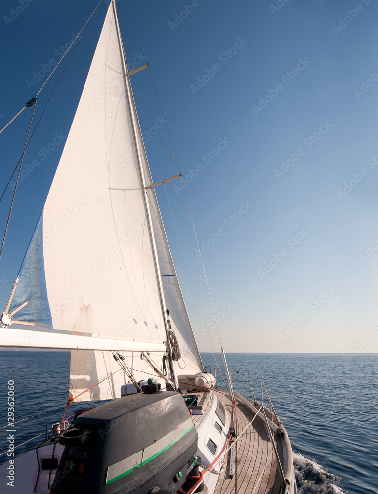 Fototapeta premium Yacht sailing in the sea, clear blue sky