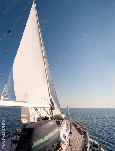 Yacht sailing in the sea, clear blue sky