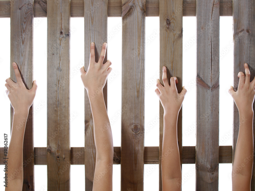 hands holding fence