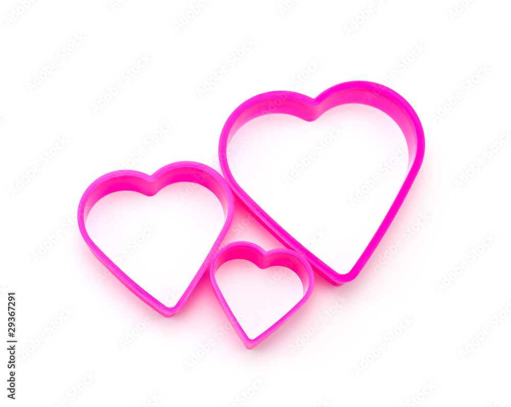 three pieces of pink plastic in heart shape isolated on white