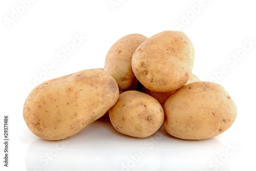 Stack of unpeeled potatoes over white background