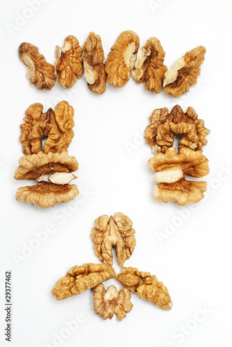 Face made of walnut kernels isolated on white
