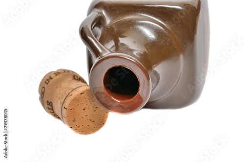 Ceramic bottle and a cork on a white background