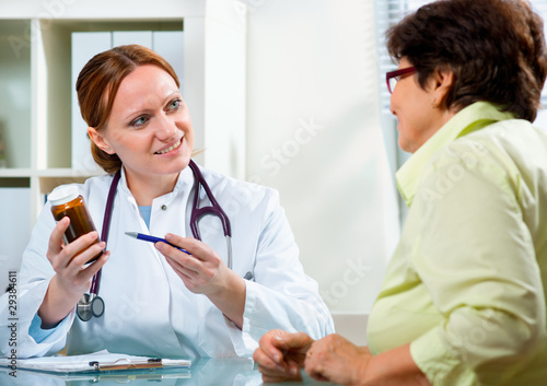 Doctor prescribes a medicine to a senior patient