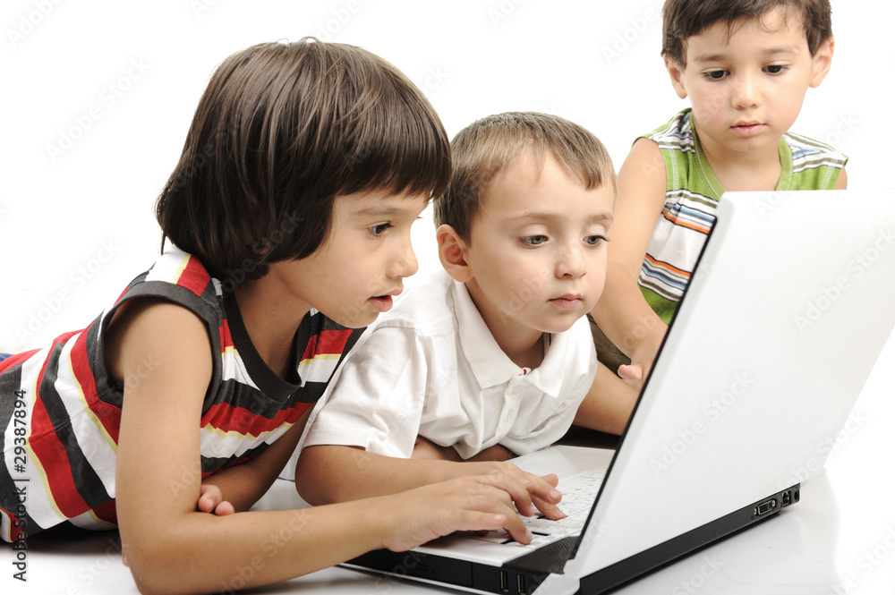 Group of children playing on white laptop together Group of children playing on white laptop together