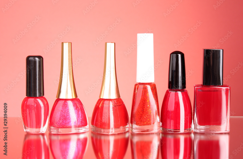 Group of nail polishes on red background Group of nail polishes on red background