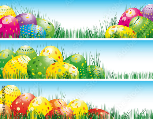 Easter banners with colorful Easter eggs in the young green gras