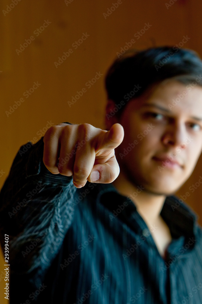 Young man pointig the finger to a camera