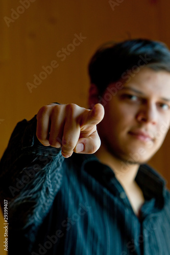 Young man pointig the finger to a camera © Chudakov