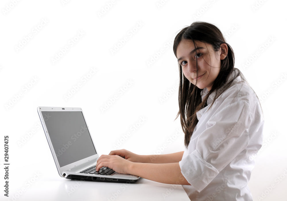 Teenager working on computer looking at the camera. Teenager working on computer looking at the camera.