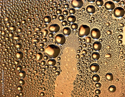 Golden water drops as background