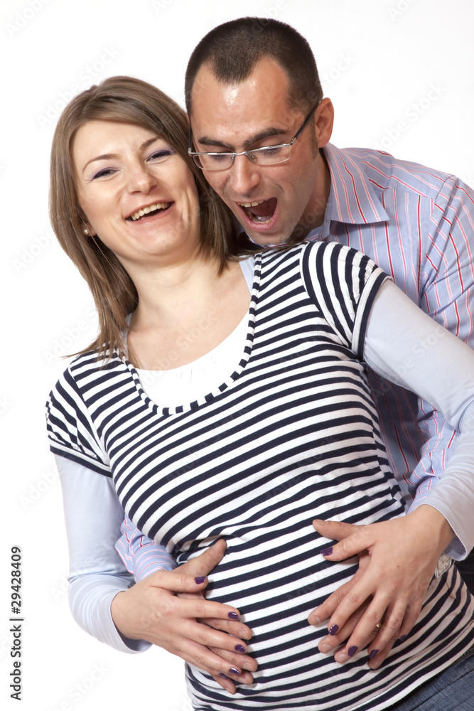 Happy young man and his pregnant wife isolated on white Happy young man and his pregnant wife isolated on white