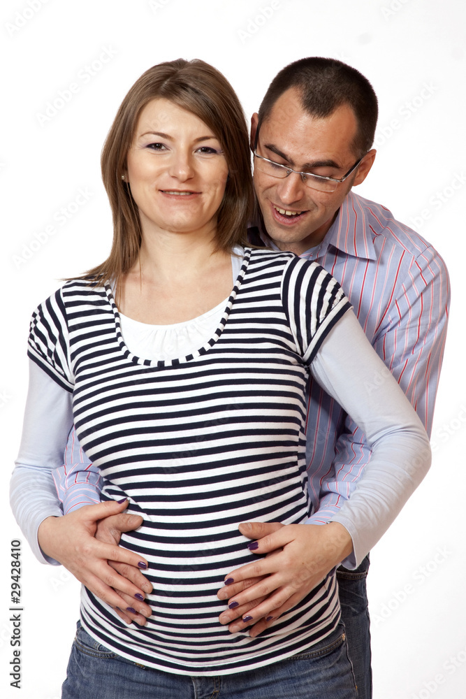 Happy young man and his pregnant wife isolated on white Happy young man and his pregnant wife isolated on white