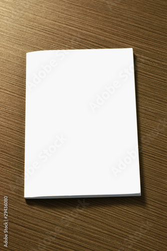 Vertical blank notebook cover on wooden table