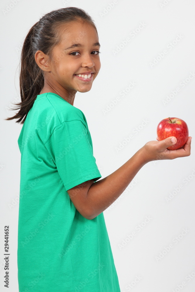 Cheerful school girl 10 smiling holding red apple Cheerful school girl 10 smiling holding red apple