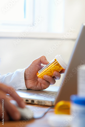 Fototapeta Naklejka Na Ścianę i Meble -  Doctor preparing online internet prescription drugs