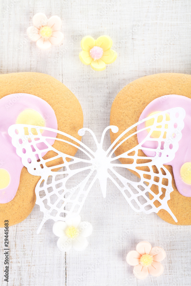 ornate paper batterfly and ginger cookies with sugar flowers