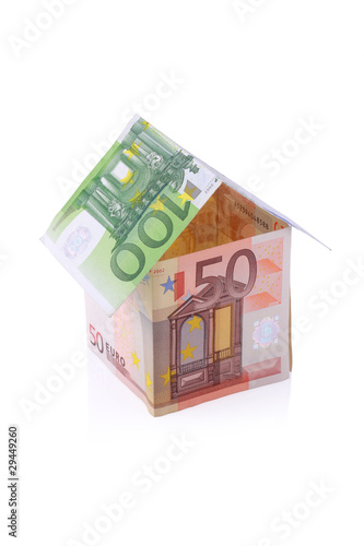 House built with Euro money bills isolated on white background