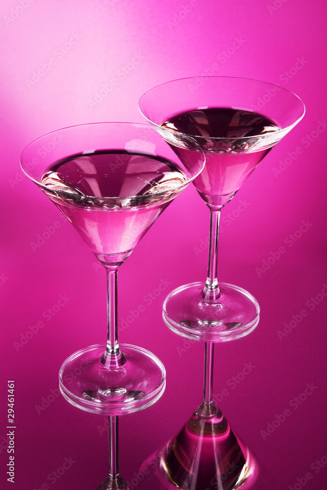 Two martini glasses on red background Two martini glasses on red background