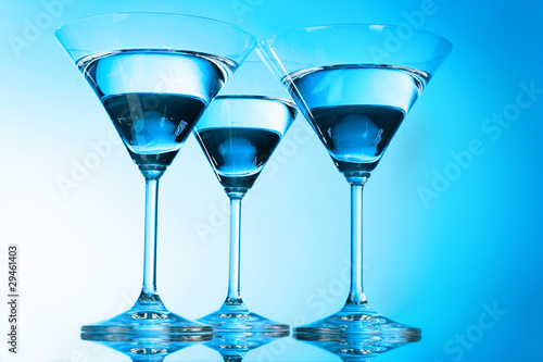 Three martini glasses on blue background