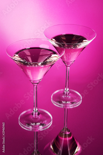Two martini glasses on red background