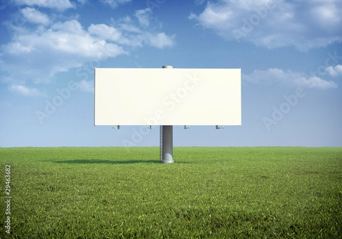 Ad billboard standing in a field of grass