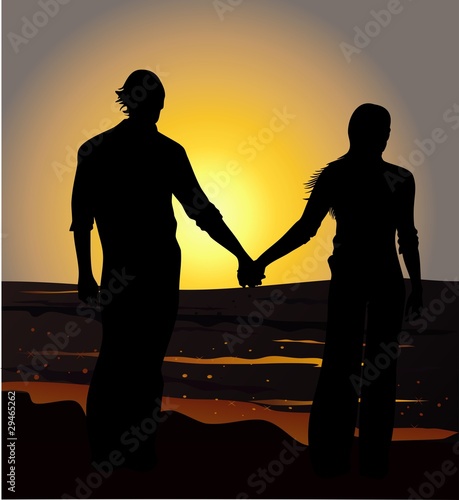 couple holding hands on the beach