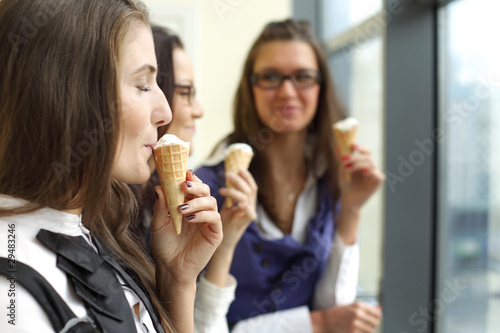 happy women licking ice cream