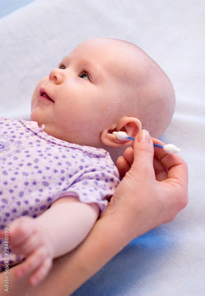 cleaning ear of baby with cotton swabs cleaning ear of baby with cotton swabs