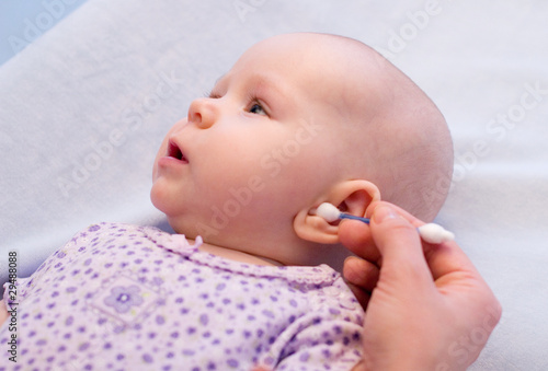 cleaning ear of baby with cotton swabs