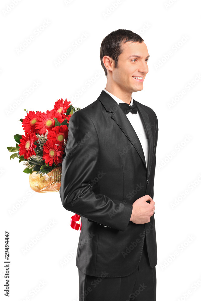 Man hiding a bouquet of flowers behind his back Man hiding a bouquet of flowers behind his back