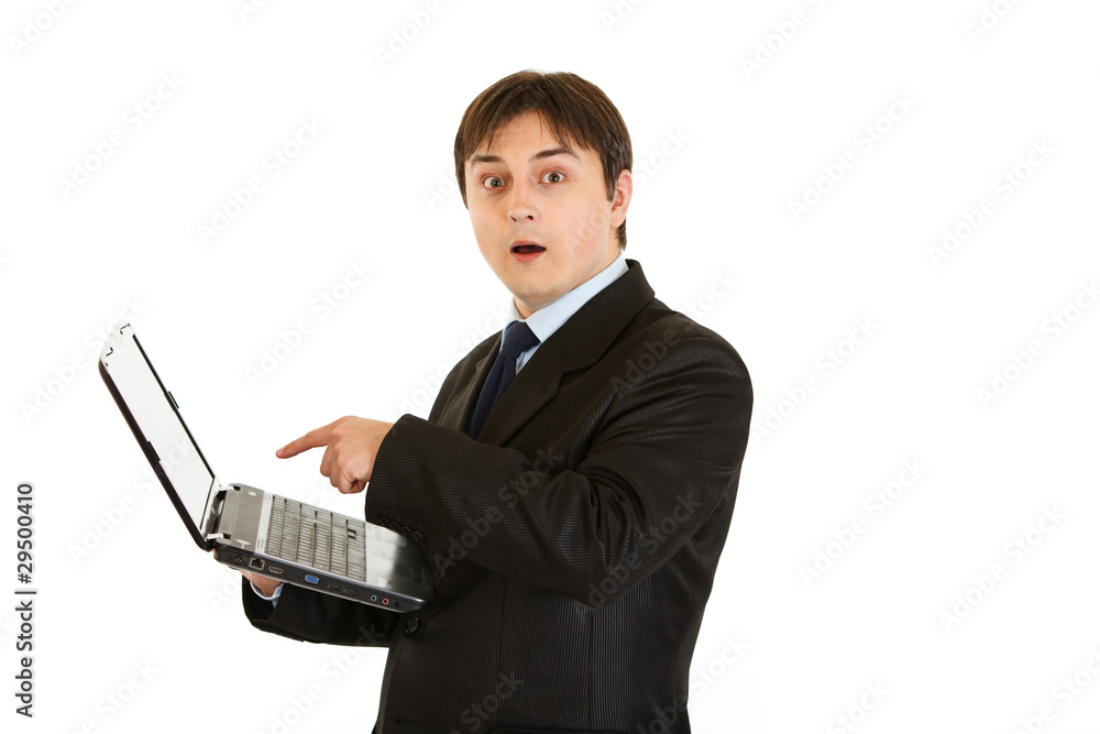 Modern businessman amazedly looks in laptops screen