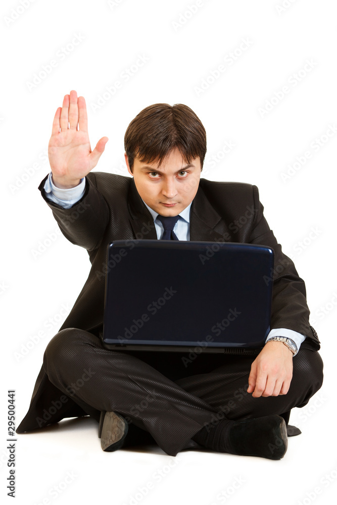Sitting on floor with laptop businessman showing stop gesture Sitting on floor with laptop businessman showing stop gesture