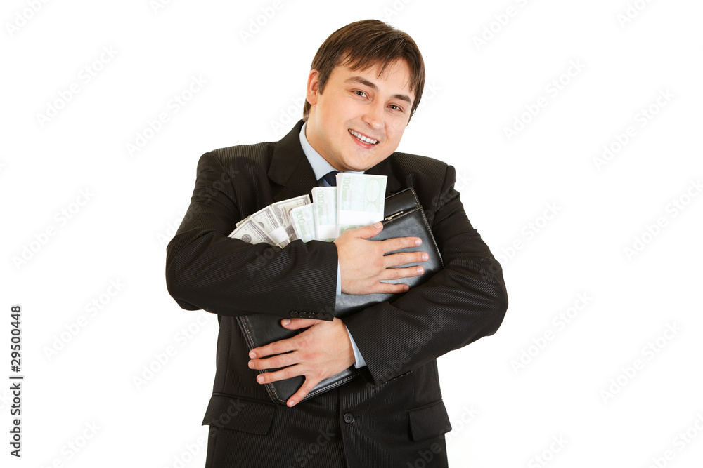 Successful businessman hugging briefcase with money in hands Successful businessman hugging briefcase with money in hands