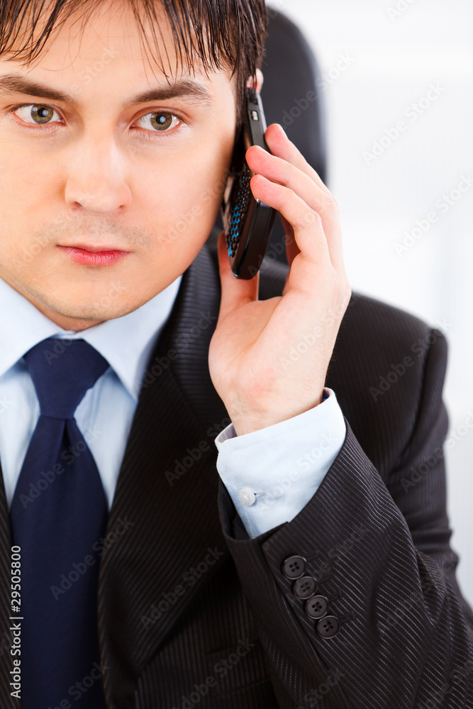 Concentrated business man talking on mobile phone. Concentrated business man talking on mobile phone.