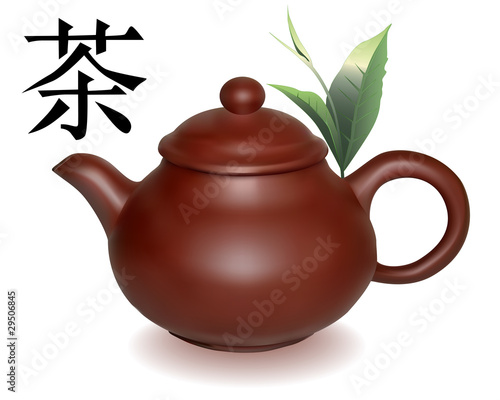Clay brewing teapot with green sheets of tea