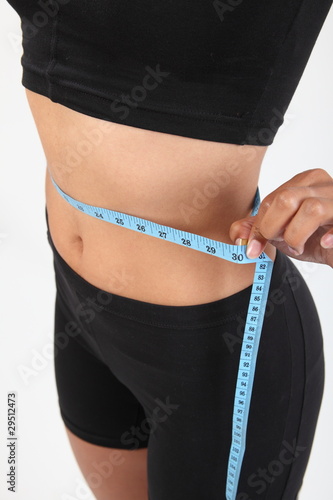 Slim healthy woman measuring waist