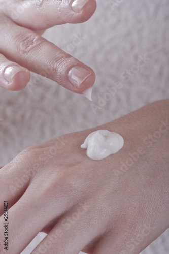 female applying cream to her hands