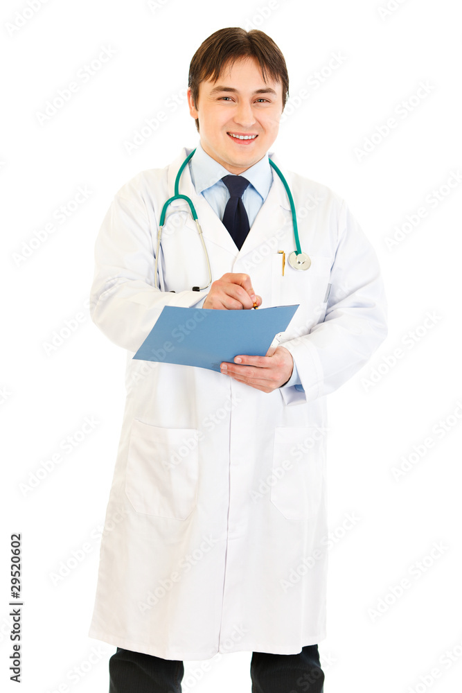 Smiling doctor writing report in medical chart of patient Smiling doctor writing report in medical chart of patient