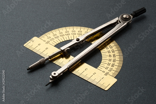 Pair of compasses and protractor isolated on white