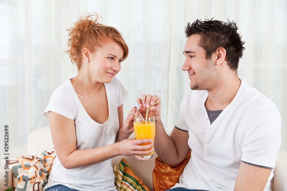 handsome boy and a beauty, young girl drinking orange juice handsome boy and a beauty, young girl drinking orange juice