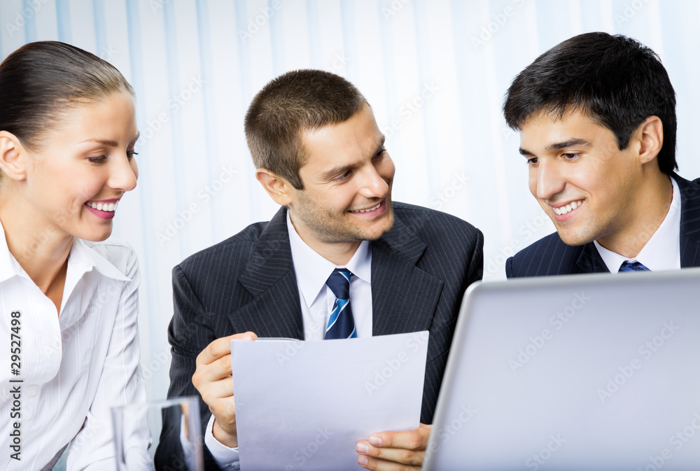 Three businesspeople working with document at office Three businesspeople working with document at office