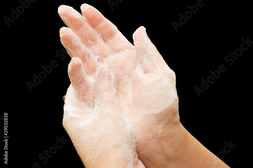 Female hands in soapsuds isolated on black © Vladimir Voronin