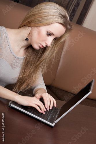 Young girl working on a laptop photo