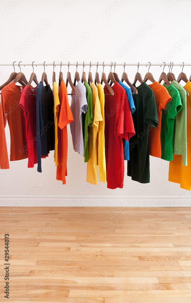 Variety of multicolored clothes on a rod